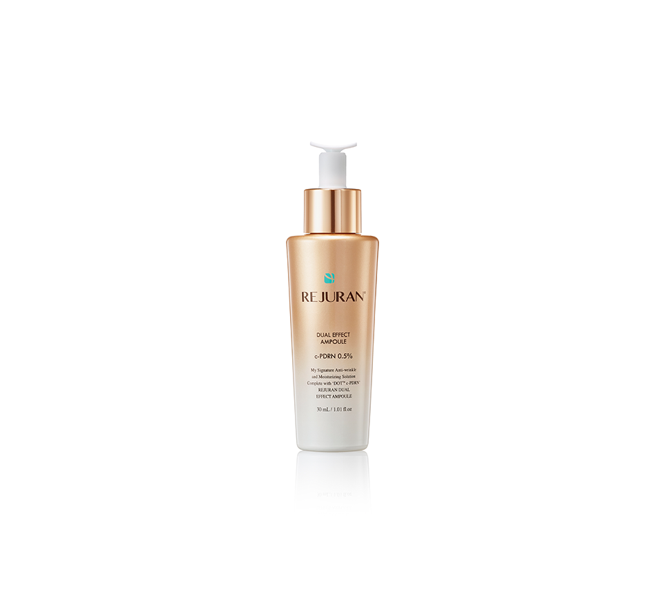 Skincare bottle with gold and white design on a white background